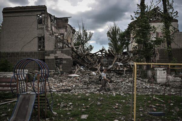 A man walks in front of a destroyed school in the city of Bakhmut in the eastern Ukrainian region of Donbas on May 28, 2022, on the 94th day of Russia's invasion of Ukraine. (Aris Messinis/AFP via Getty Images)