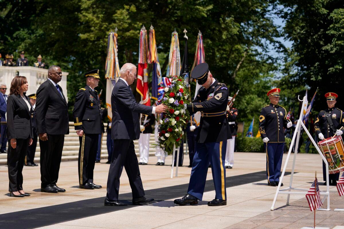 President Joe Biden lays a wreath at The Tomb of the Unknown Soldier at Arlington National Cemetery in Arlington, Va., on May 30, 2022. Vice President Kamala Harris, left, and Defense Secretary Lloyd Austin, second from left, watch. (Andrew Harnik/AP Photo)