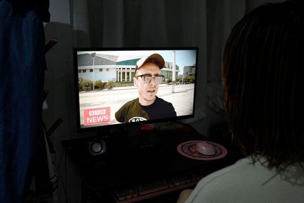 British vlogger Jason Lightfoot speaking on his YouTube channel as seen on a computer screen in Beijing on Sept. 2, 2021. With their videos "debunking" allegations of human rights abuses and diatribes on Western "conspiracies" against China, an unlikely set of foreigners are loudly defending Beijing from its international critics. (Jade Gao/AFP via Getty Images)