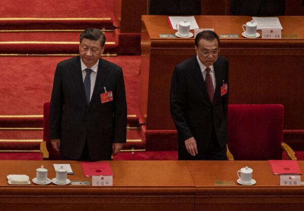Chinese leader Xi Jinping (L) and Premier Li Keqiang arrive for the closing session of the National People's Congress at the Great Hall of the People in Beijing, China, on March 11, 2022. (Kevin Frayer/Getty Images)
