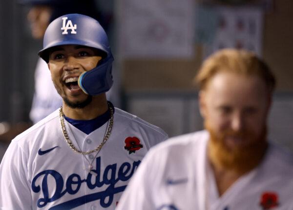 Mookie Betts #50 of the Los Angeles Dodgers celebrates his solo homerun in the dugout behind Justin Turner #10, to trial 4-2 to the Pittsburgh Pirates, during the fifth inning at Dodger Stadium, in Los Angeles, on May 30, 2022. (Harry How/Getty Images)