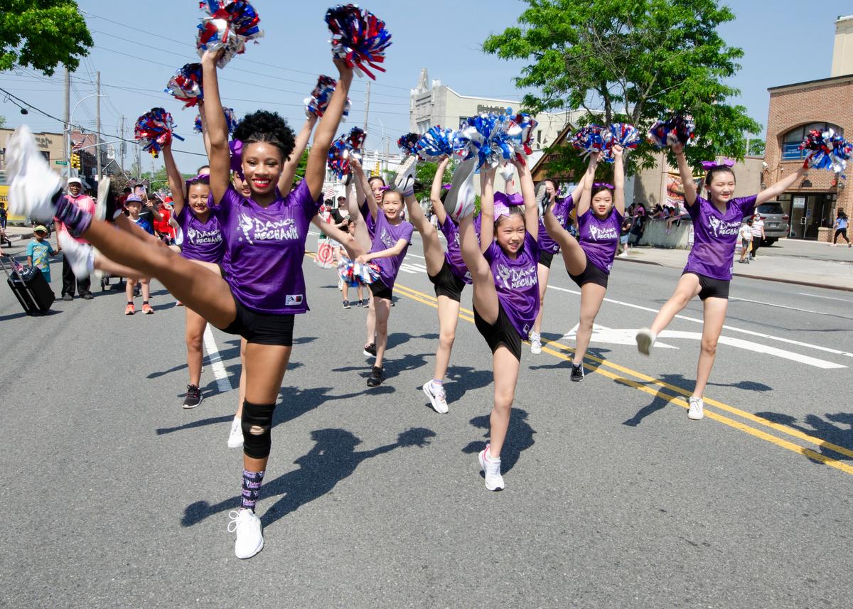 Members of Dance Mechanix in Great Neck, New York show us why it's called a kick line as they march in the 2022 Memorial Day parade in Little Neck-Douglaston, N.Y., on May 30, 2022. (Dave Paone:The Epoch Times)