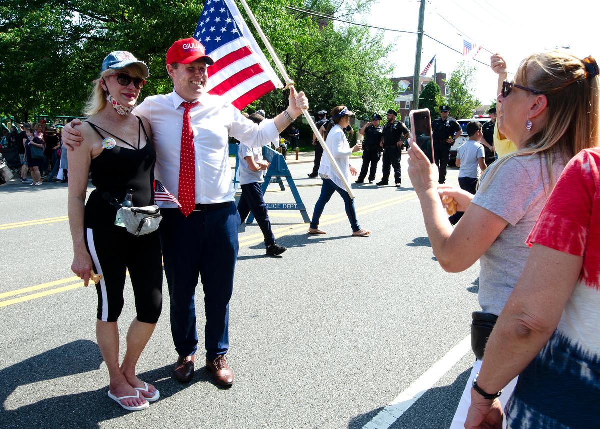 Republican New York gubernatorial hopeful Andrew Giuliani poses for a photo with a supporter after the 2022 Memorial Day parade in Little Neck-Douglaston, N.Y., on May 30, 2022. (Dave Paone:The Epoch Times)