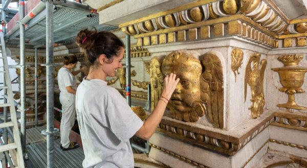 Conservator working on Istrian stone relief at Frari. (SaveVenice)