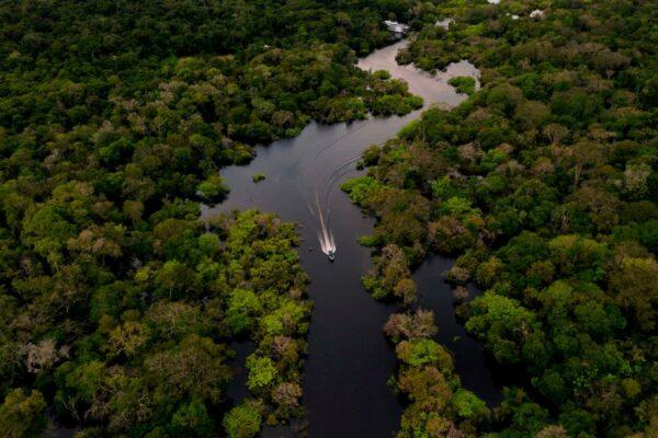 Aerial view showing a boat speeding on the Jurura river in the municipality of Carauari, in the heart of the Brazilian Amazon Forest, on March 15, 2020. (Florence Goisnard/AFP via Getty Images)