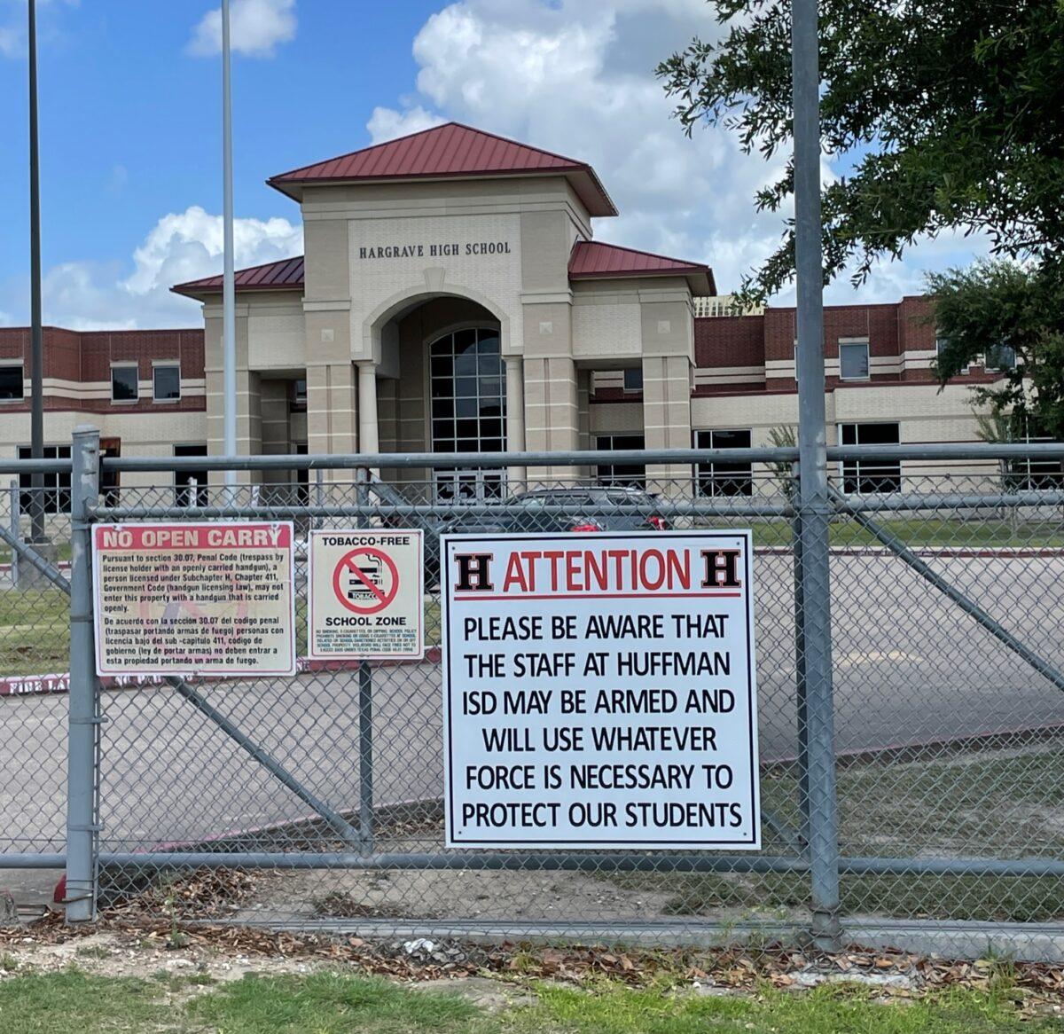 Signage at Hargrave High School in the Huffman Independent School District in Texas warns those who may enter school property with ill intent that open carry is prohibited and that staff may be armed with concealed weapons and will use whatever force is necessary to protect the students in their charge. (Courtesy of the Huffman Independent School District)