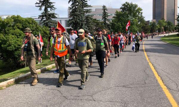 Veteran James Topp walks with supporters on the last day of his 4,300-kilometre trek from Vancouver to Ottawa on June 30, 2022. (Noé Chartier/The Epoch Times)