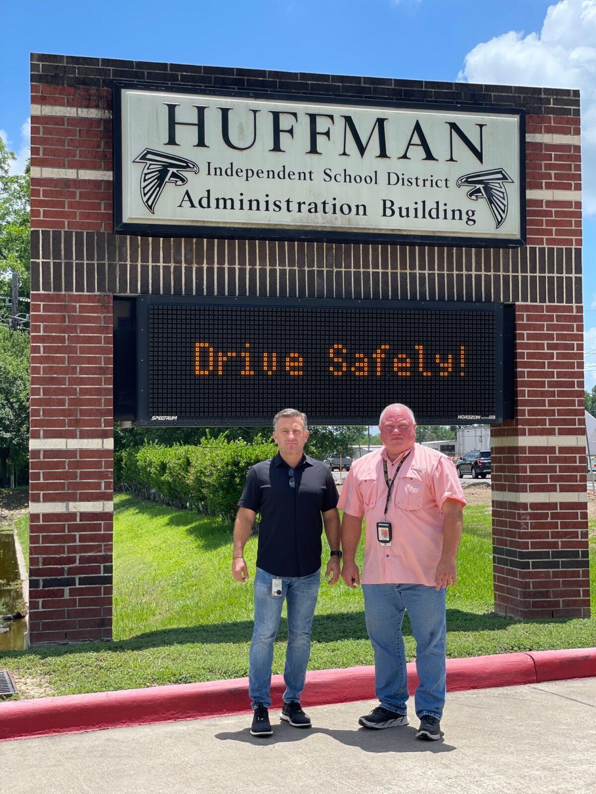 Huffman Independent School District Superintendent of Schools Benny Soileau (L) and Chief of Police David Williams for the Huffman Independent School District, stand before the sign for the Huffman Independent School District Administration Building. (Courtesy of the Huffman Independent School District)