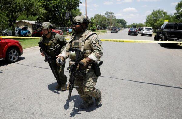 Law enforcement personnel run away from the scene of a shooting near Robb Elementary School in Uvalde, Texas, on May 24, 2022. (Reuters/Marco Bello)