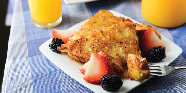 This is a French toast recipe with a tropical twist. Take some good ol’ Texas toast and dredge it in the typical mixture of eggs and milk — but also add a dash of coconut extract and dip it into shredded coconut. (Photo courtesy of Happy Money Saver) <a href="https://www.thedailymeal.com/best-recipes/coconut-french-toast-breakfast-brunch">For the Coconut French Toast recipe, click here</a>.