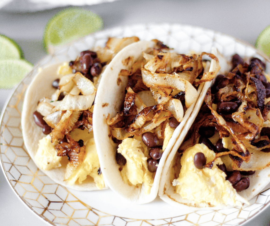 Making these breakfast tacos for brunch works out nicely since you’ll need an added 30 minutes to slowly (and properly) caramelize the onions. With sweet and spicy onions, <a href="https://www.thedailymeal.com/celebrity-chefs-scrambled-eggs">fluffy scrambled eggs</a>, black beans and some tortillas, you’ve got a filling and flavor-packed meal. (Photo courtesy of Bits and Bites) <a href="https://www.thedailymeal.com/best-recipes/sweet-chili-caramelized-onion-breakfast-tacos">For the Sweet Chili Caramelized Onion Breakfast Tacos recipe, click here</a>.