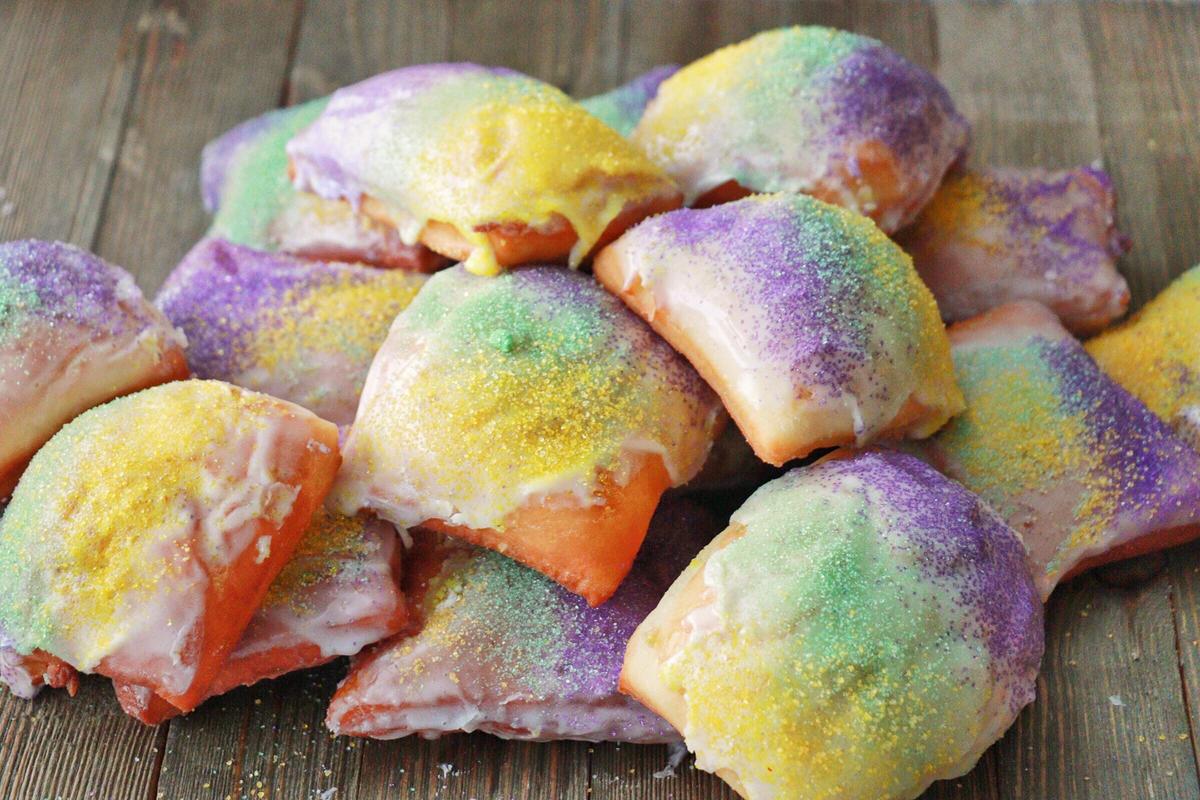 These King Cake Beignets would be the main attraction at any Mardi Gras-themed brunch party. This recipe takes the light and airy dough of a beignet and blends it with the colorful icing of a king cake. To make this <a href="https://www.thedailymeal.com/best-recipes/how-make-famous-new-orleans-dishes-according-local-chefs">famous New Orleans dish</a>, it’s best to let the dough rest overnight and definitely don’t skimp on the bedazzling. (Photo Courtesy of Kenneth Temple) <a href="https://www.thedailymeal.com/recipes/king-cake-beignets">For the King Cake Beignet recipe, click here.</a>