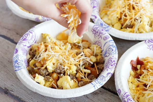 Breakfast bowls are terrific for family-style brunch parties. You can either assemble each bowl before serving or keep the <a href="https://www.thedailymeal.com/cook/scrambled-eggs-light-fluffy">scrambled eggs</a>, potatoes, meat and cheese in separate dishes and let your guests build their own. (Photo courtesy of Happy Money Saver) <a href="https://www.thedailymeal.com/best-recipes/breakfast-bowl-freezer-cheap-meal">For the Breakfast Bowl recipe, click here</a>.