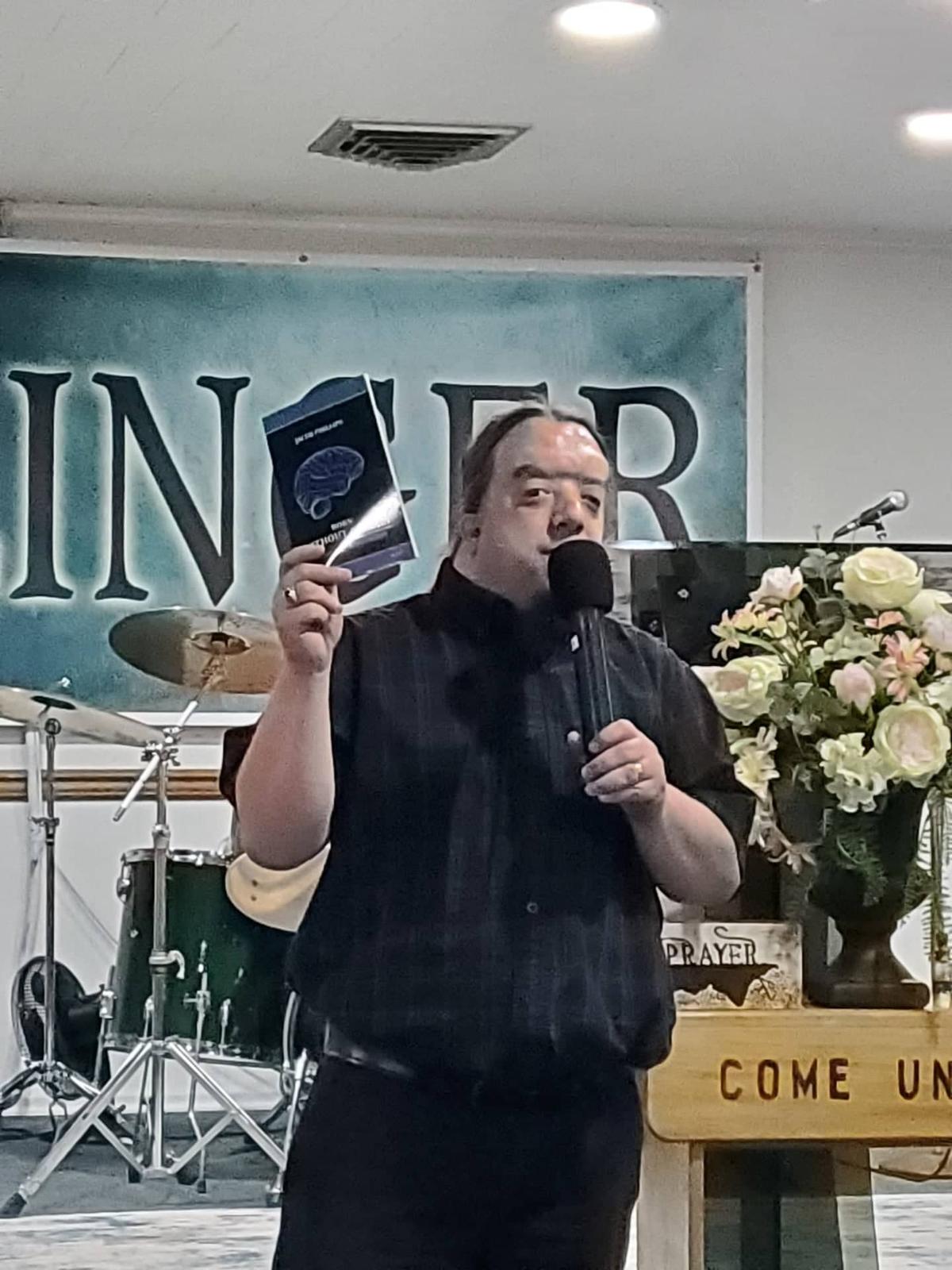 Phillips at a church introducing his book, "<a href="https://www.amazon.com/Born-Without-Brain-Story-Phillip/dp/1948747103">Born Without a Brain</a>." (Courtesy of Jacob Phillips)