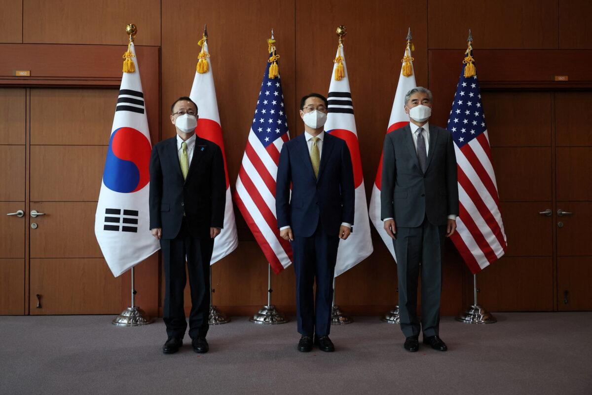 Kim Gunn, South Korea's new special representative for Korean Peninsula peace and security affairs (C), his U.S. counterpart Sung Kim (R), and Japanese counterpart Takehiro Funakoshi pose for photographs before their meeting at the Foreign Ministry in Seoul, South Korea, on June 3, 2022. (Kim Hong-Ji/Pool/Reuter