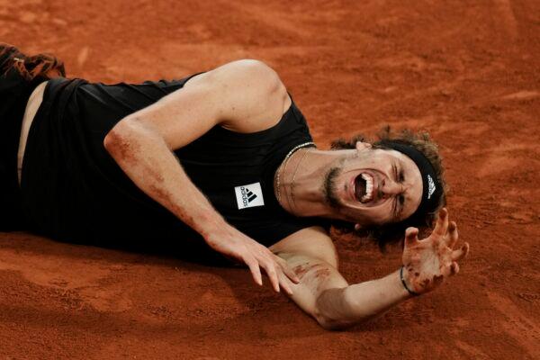 Germany's Alexander Zverev grimaces in pain after twisting his ankle during the semifinal match against Spain's Rafael Nadal at the French Open tennis tournament in Roland Garros stadium in Paris on June 3, 2022. (Thibault Camus/AP Photo)