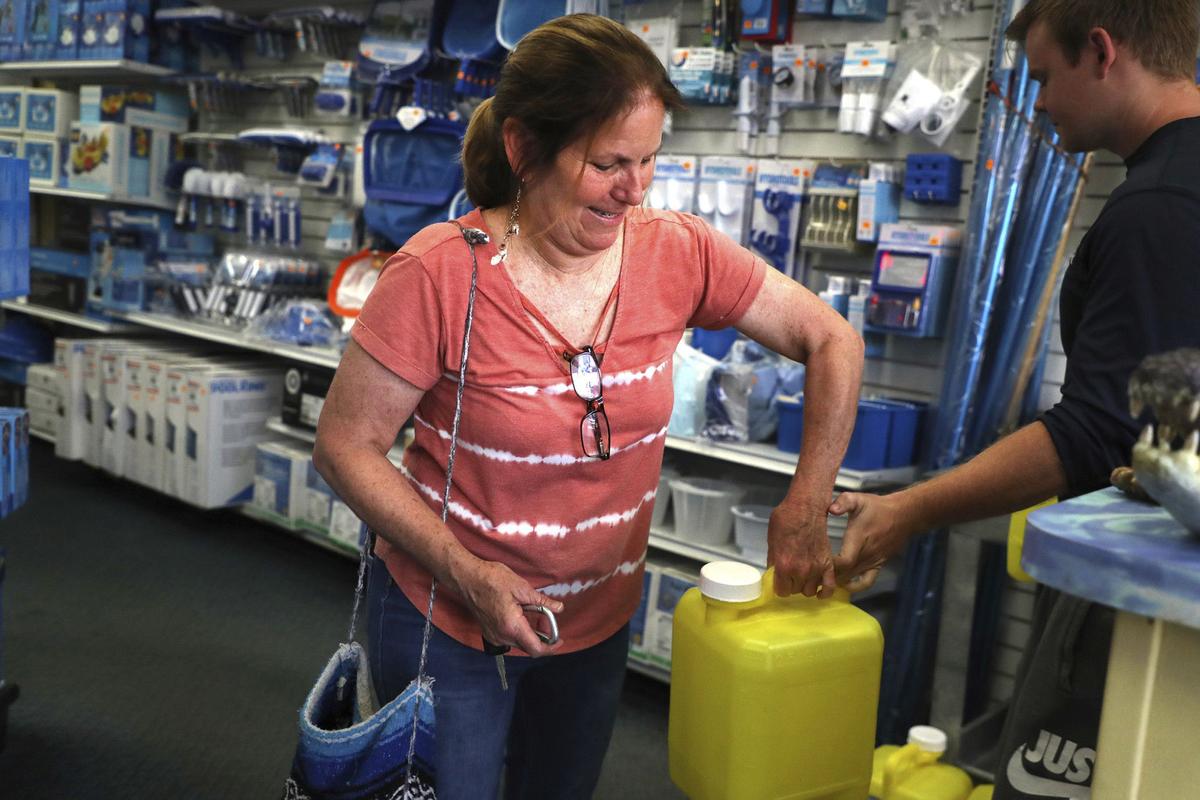 Jennifer Hackler purchases chlorine for her pool at Allbrite Pool Supplies in Coral Springs, Florida, on April 25, 2022. Shocked by skyrocketing prices for chlorine sanitizing tablets, many pool owners have switched to liquid chlorine, which requires a higher level of maintenance and additional chemicals. (Carline Jean/South Florida Sun Sentinel/TNS)