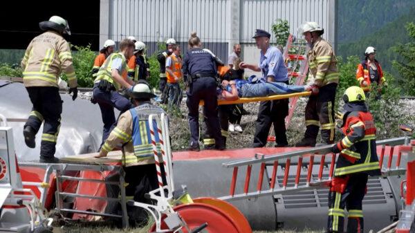Policemen and firemen rescuing a person from a derailed train in Burgrain near Garmisch-Partenkirchen, southern Germany, on June 3, 2022. (STR/Network Pictures/AFP via Getty Images)