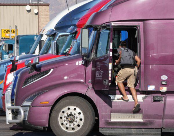 A trucker gets in the cab of his truck after he fueled up at the Love's Truck Stop in Springville, Utah, on Dec. 1, 2021. (GEORGE FREY/AFP via Getty Images)