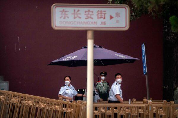 Security officers wearing face masks stand at a checkpoint near Tiananmen Square in Beijing, on June 4, 2022. (Mark Schiefelbein/AP Photo)