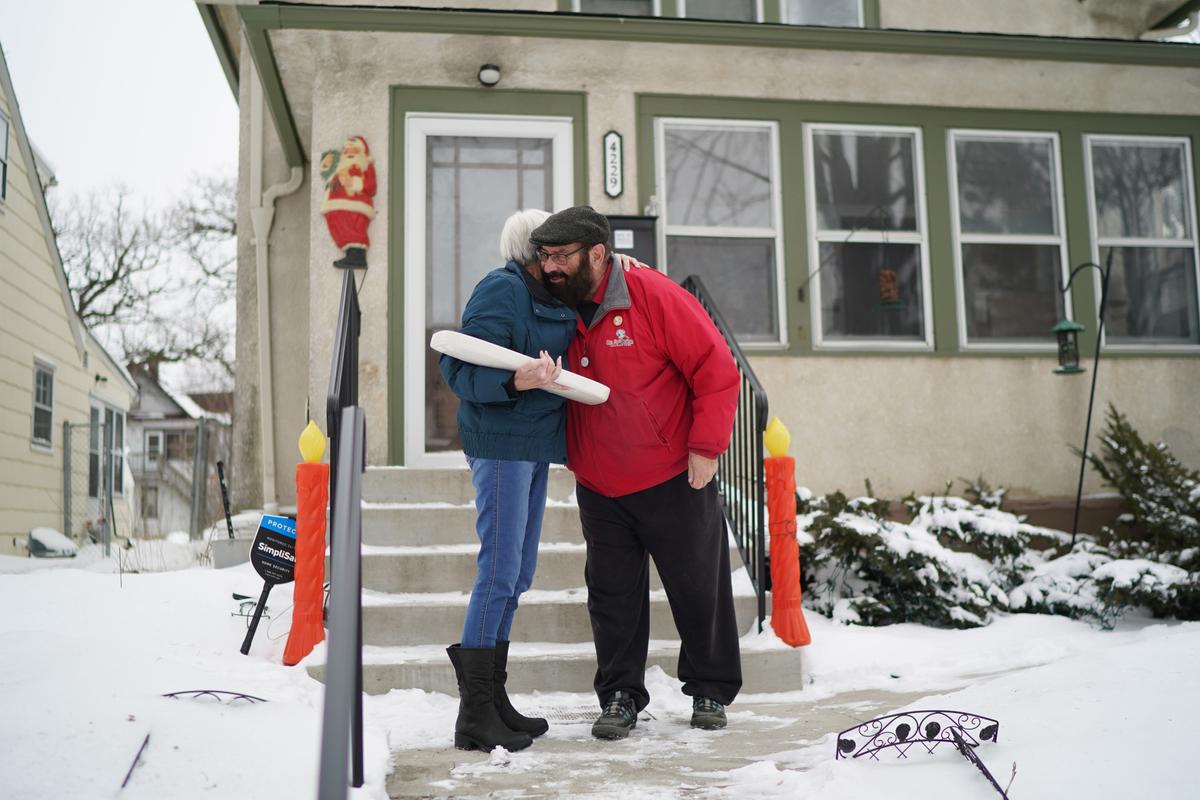 Homeowner Alan Peters turning over the signed toilet tank lid to plumber Otto Johnson's descendant, granddaughter Lynda Bornhoeft. (Glen Stubbe/Minneapolis Star Tribune/TNS)