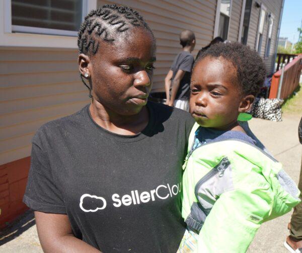 Samantha, a young Angolan mother, and her child outside the family shelter in Portland, Maine, on May 25, 2022. (Steven Kovac/The Epoch Times)