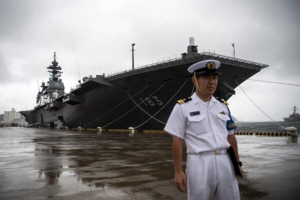 A Japanese Navy officer stands near the Japanese navy's then helicopter carrier JS Izumo in Yokosuka, Japan on Aug. 31, 2017. The carrier has recently been converted to take fixed-wing aircraft. (Carl Court/Getty Images)