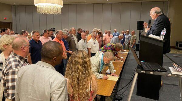 Participants step forward on July 27, 2021, in Edmond, Okla., at the end of Liberty Pastors training to sign their names on a "Muster Roll Parchment," committing to the group's mission. (Courtesy of Liberty Pastors)