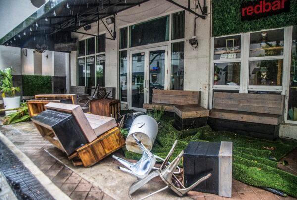 Furniture and plants from the RedBar Brickell bar litter the sidewalk after rainfall from Tropical Storm Alex caused flooding in the Brickell area near downtown Miami on June 4, 2022. (Pedro Portal/Miami Herald via AP)