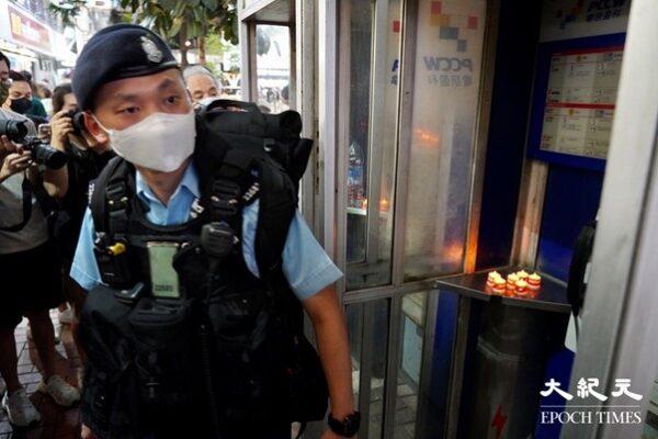 Several electronic candles were found inside a public telephone booth in Causeway Bay on June 4, 2022. Police took them away. (Yu Gong / The Epoch Times)