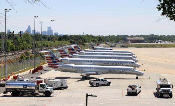 Airplanes sit on the tarmac at Charlotte Douglas International Airport with the city skyline in the background in Charlotte, N.C., on April 21, 2020. (Streeter Lecka/Getty Images)