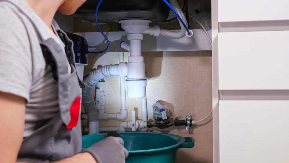 The majority of plumbing leaks happen at connection points. Use a flashlight to check and, if necessary, tighten or replace them.<br/>(Lenar Nigmatullin/Shutterstock)