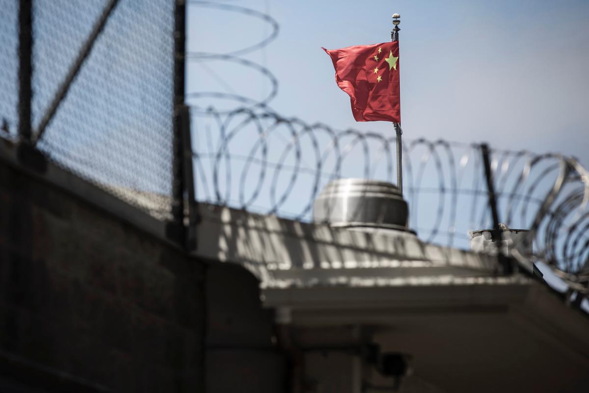 The flag of the People's Republic of China flies behind barbed wire at the Consulate General of the People's Republic of China in San Francisco on July 23, 2020. (Philip Pacheco/AFP via Getty Images)