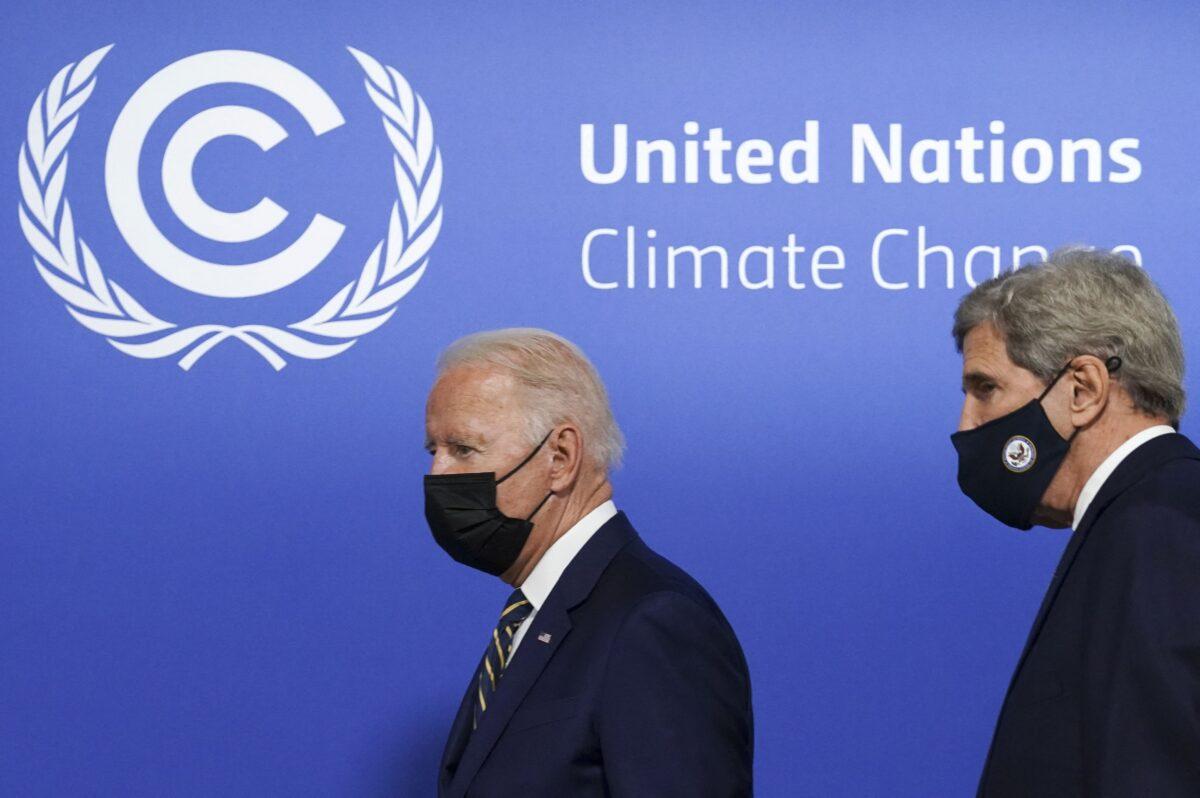 U.S. President Joe Biden (L), flanked by U.S. Climate Adviser John Kerry, arrives to attend a meeting focused on action and solidarity at the U.N. Climate Change Conference (COP26) in Glasgow, on Nov. 1, 2021. (Kevin Lamarque/POOL/AFP via Getty Images)