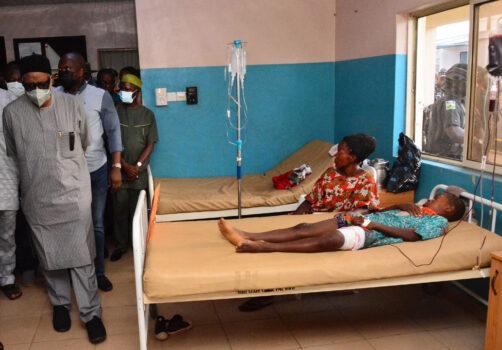 State officials walk past injured victims on hospital beds being treated for wounds following an attack by gunmen at St. Francis Catholic Church in Owo town, southwest Nigeria on June 5, 2022. (AFP via Getty Images)