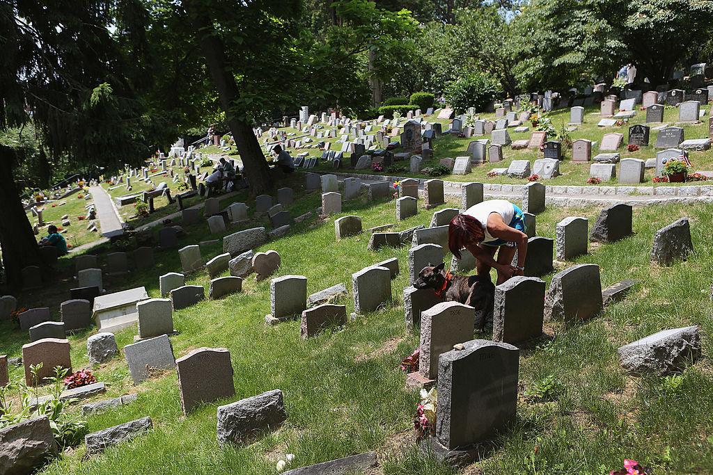A pet lover visits a grave during a memorial service for military working dogs at the Hartsdale Pet Cemetery in Hartsdale, N.Y., on June 10, 2012. (John Moore/Getty Images)
