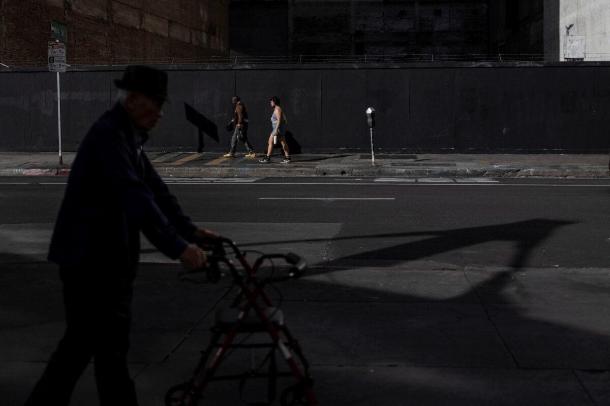 Local residents walk along an empty street as temperatures reach over 95 degrees F (over 35 degrees C) temperatures in downtown Los Angeles on April 7, 2022. (Carlos Barria/Reuters)