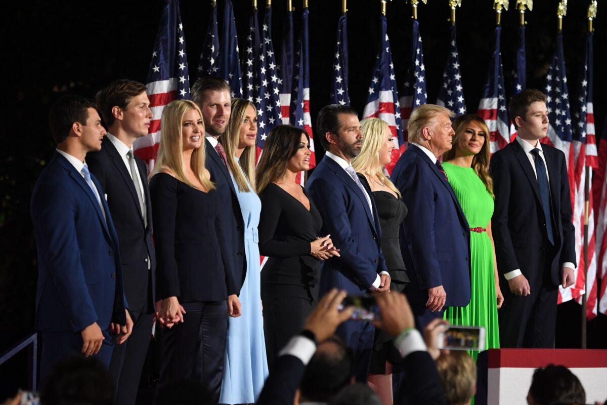 (R–L) Barron Trump, First Lady Melania Trump, President Donald Trump, Tiffany Trump, Donald Trump Jr., Kimberly Guilfoyle, Lara Trump, Eric Trump, Ivanka Trump, Jared Kushner, and Michael Boulos stand after the president delivered his acceptance speech for the Republican Party nomination for reelection during the final day of the Republican National Convention at the South Lawn of the White House on Aug. 27, 2020. (Saul Loeb/AFP via Getty Images)