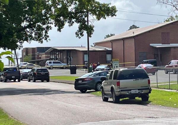 Officials gather outside Walnut Park Elementary School where a man was shot to death by police in Gadsden, Ala., on June 9, 2022. (William Thornton/The Birmingham News via AP)