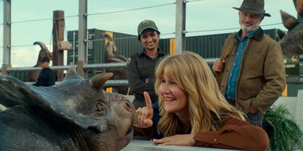 Ellie Sattler (Laura Dern, C) says hello to a baby triceratops, in "Jurassic World: Dominion." (Amblin Entertainment/Universal Pictures)
