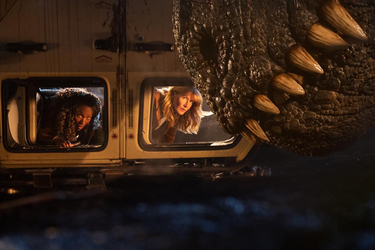 Pilot and smuggler Kayla Watts (DeWanda Wise, L) and Ellie Sattler (Laura Dern) re-create a tableau from the original "Jurassic Park" in "Jurassic World: Dominion." (Amblin Entertainment/Universal Pictures)