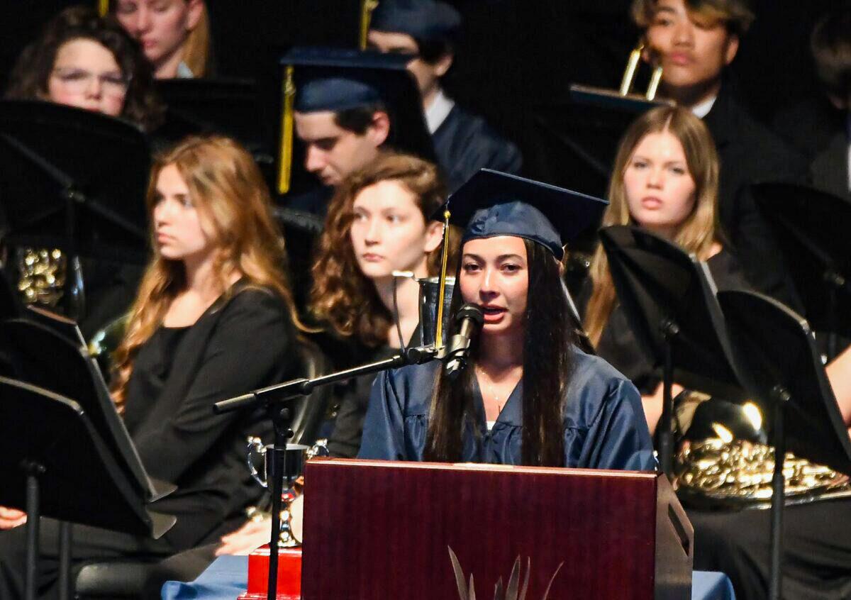 The pandemic has made graduating high school harder than usual for many American students. Photo of Senior speaker Kylie Ossege addressing the seniors at the Oxford High School graduation at Pine Knob Music Theater in Independence Township, Mich. on May 19, 2022. (Daniel Mears/The Detroit News/TNS)