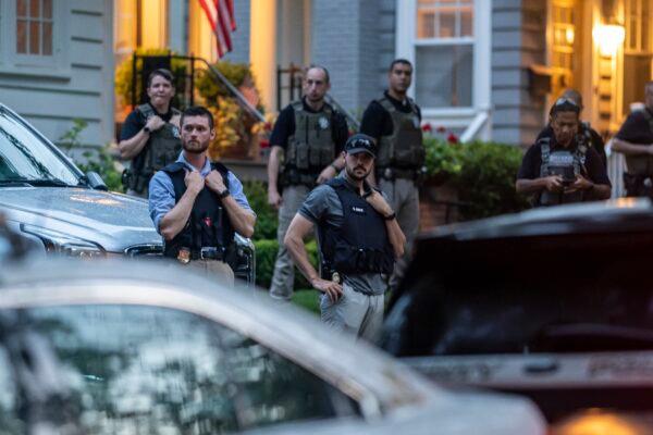 Law enforcement officers stand guard as protesters march past Supreme Court Justice Brett Kavanaugh's home in Chevy Chase, Md., on June 8, 2022. (Nathan Howard/Getty Images)