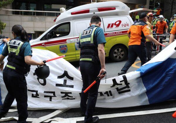 South Korean police officers and firefighters check around the scene of a fire in Daegu, South Korea, on June 9, 2022. (Park Se-jin/Yonhap via AP)
