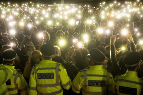 People in the crowd turning on their phone torches in Clapham Common, London, for a vigil for Sarah Everard in March 2021. (PA)