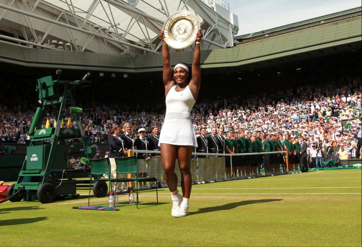 Serena Williams of the United States holds up the trophy after winning the women's singles final against Garbine Muguruza of Spain at the All England Lawn Tennis Championships in Wimbledon, London, on July 11, 2015. (Sean Dempsey/Pool via AP)