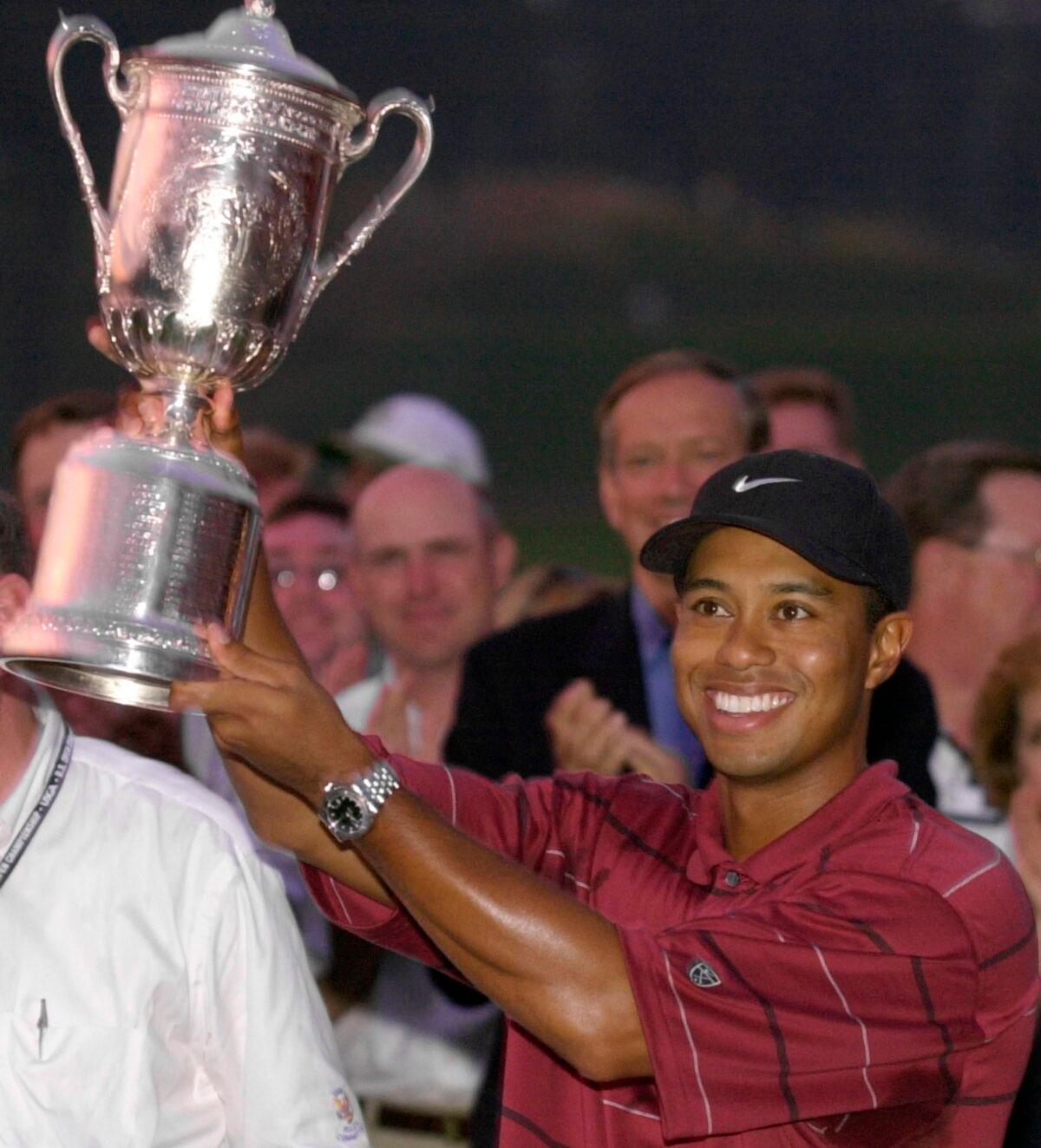 Tiger Woods holds the 2002 U.S. Open golf tournament trophy after winning at the Black Course of Bethpage State Park in Farmingdale, New York. (Charles Krupa/ AP Photo)