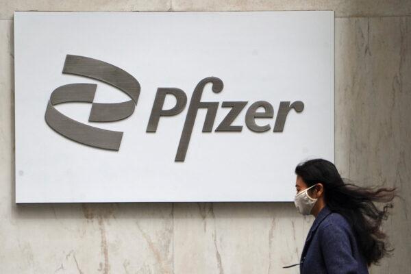 A person walks past a Pfizer logo amid the COVID-19 pandemic in the Manhattan borough of New York, on April 1, 2021. (Carlo Allegri/Reuters)