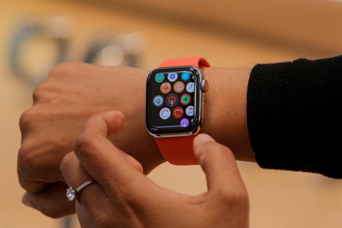 An Apple Store employee shows the Series 5 Apple Watch during the preview of the redesigned and reimagined Apple Fifth Avenue store in New York on Sept. 19, 2019. (Brendan McDermid/Reuters)
