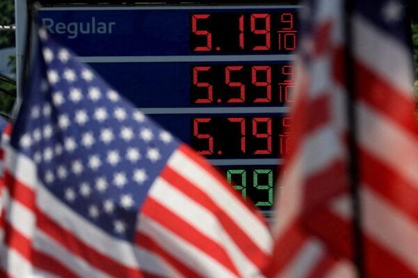Gasoline prices at an Exxon gas station behind an American flag in Edgewater, New Jersey, on June 14, 2022. (Mike Segar/Reuters)
